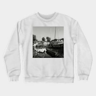 Boats moored at a harbour near Hickling Broad, Norfolk, UK Crewneck Sweatshirt